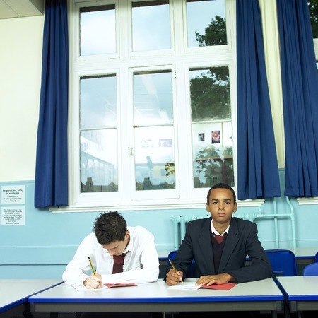 Boys writing in the classroomの写真素材