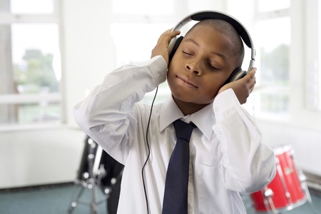 Boy listening to music on the headphonesの写真素材