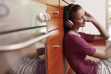 Woman listening to music on headphonesの写真素材