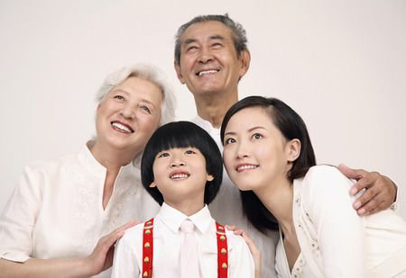 Woman and boy posing with senior coupleの写真素材