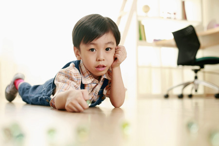 Boy playing marblesの写真素材