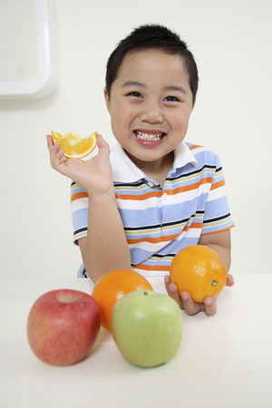 Boy posing with fruitsの写真素材