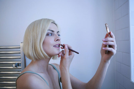 Woman applying lip linerの写真素材