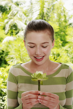 Woman holding a flowerの写真素材