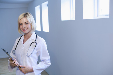 Woman in lab coat smilingの写真素材