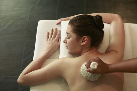 Woman enjoying a back massageの写真素材