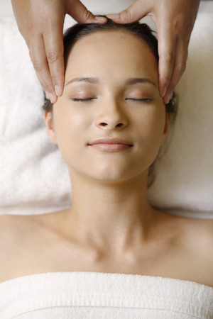 Woman enjoying a head massageの写真素材