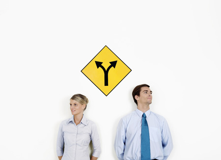 Businessman and businesswoman looking at different directions