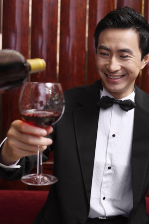 Man holding up wine glassの写真素材