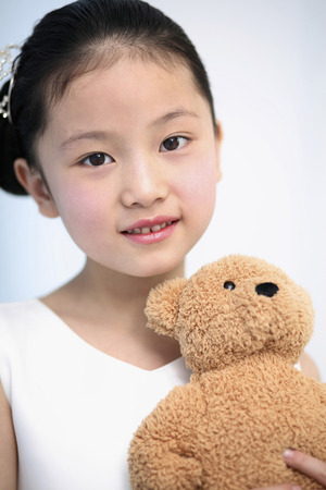 Girl holding soft toyの写真素材