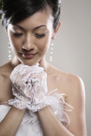 Woman closing her eyes and making a wishの写真素材