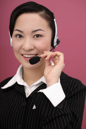 Businesswoman talking on headsetの写真素材