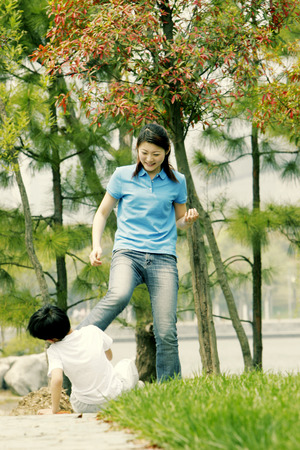 A woman kicking her brother の写真素材