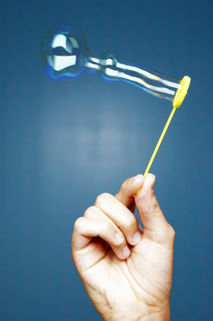 Hand playing with bubblesの写真素材