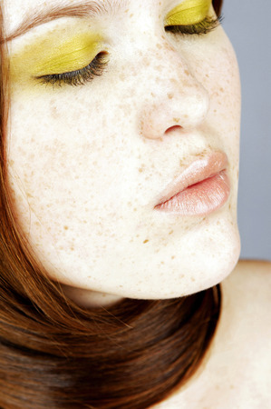 Woman tying her long hair around her neckの写真素材