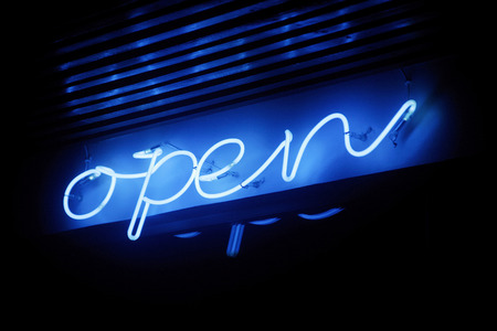 Blue neon open sign illuminating under the dark