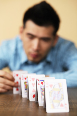 Businessman arranging playing cardsの写真素材