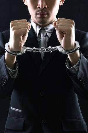 Businessman in handcuffsの写真素材