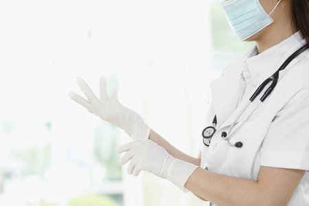 Female doctor wearing surgical glovesの写真素材