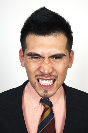 Angry businessman clenching teethの写真素材