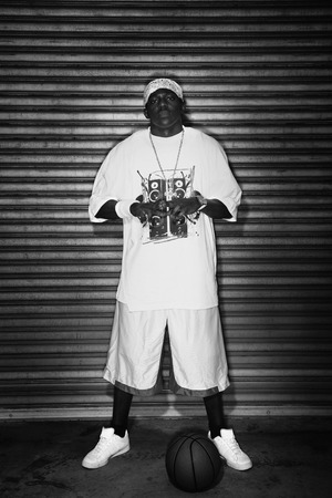 Man standing with basketball on the ground in front of him