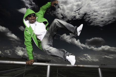 Man jumping over railing