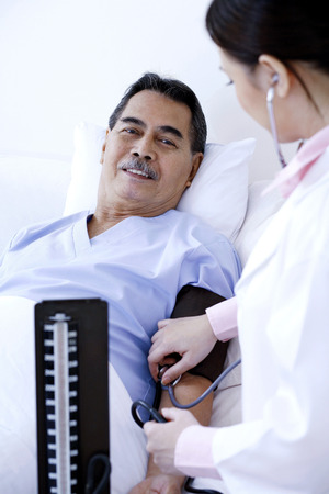 Doctor measuring blood pressureの写真素材