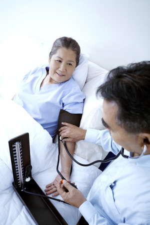 Doctor measuring blood pressureの写真素材