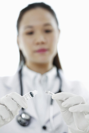 Female doctor with a syringeの写真素材