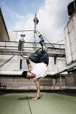 Young man doing a breakdance moveの写真素材