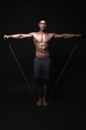 Man exercising with resistance bandsの写真素材