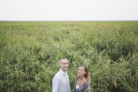 Man and woman smiling in the field