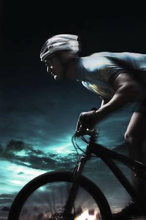 Male cyclist riding on bicycleの写真素材