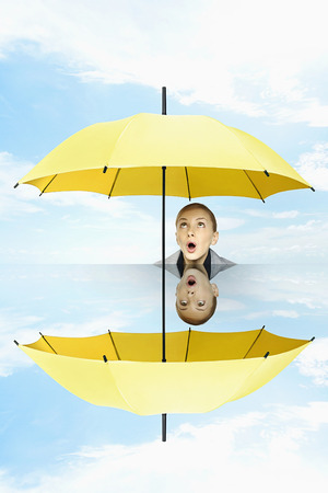 Businesswoman holding umbrella in conference roomの写真素材