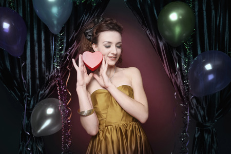 Woman smiling and holding gift boxの写真素材