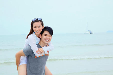 Man giving woman piggyback rideの写真素材