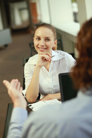 Businesswoman listening to businessman's explanationの写真素材