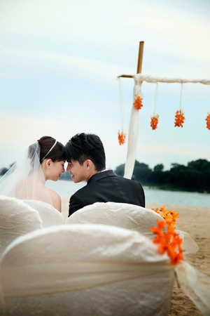Bride and groom at their beach wedding ceremonyの写真素材