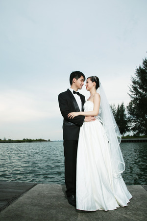 Bride and groom posing outdoorsの写真素材
