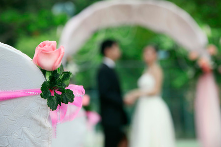 Bride and groom at their wedding ceremony, focus on chairの写真素材