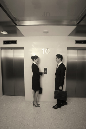 Business people waiting for elevator