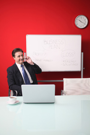 Businessman talking on telephone headsetの写真素材