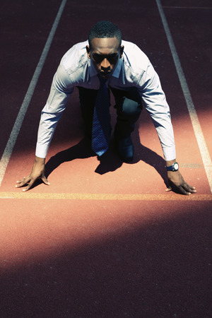 Businessman crouching on starting lineの写真素材