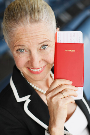 Businesswoman showing her passport in airport loungeの写真素材
