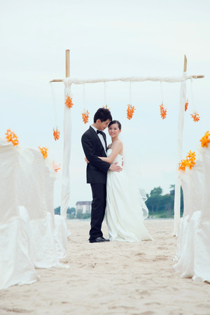 Bride and groom at their beach wedding ceremonyの写真素材