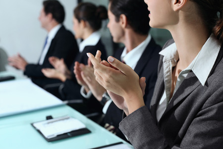 Business people clapping hands at meetingの写真素材