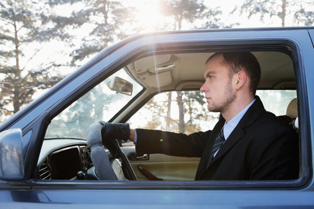 Businessman driving on winter day