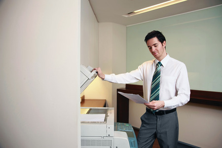 Businessman using photocopierの写真素材