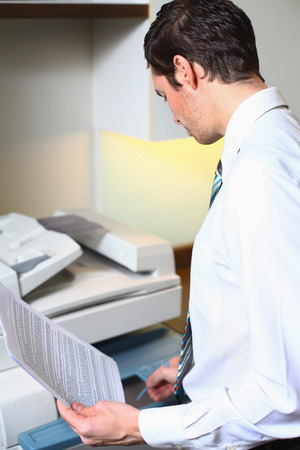 Businessman using photocopier