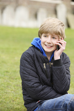 Boy using mobile phoneの写真素材